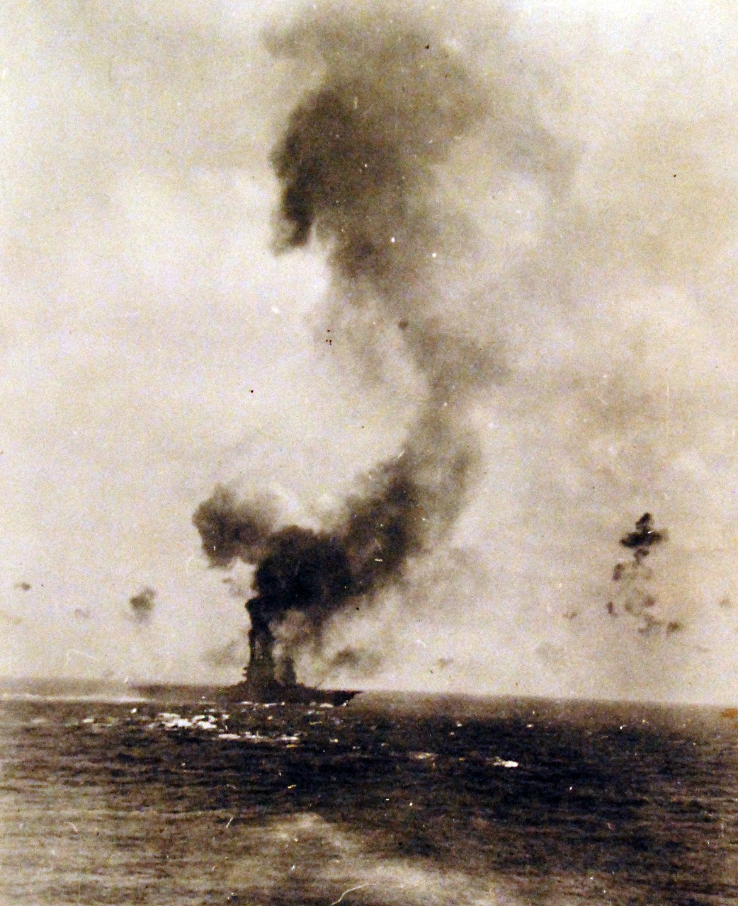 80-G-16665:   Battle of the Coral Sea, May 1942.  A "mushroom cloud" rises after a heavy explosion on board USS Lexington (CV-2), 8 May 1942. This is probably the "great explosion" from the detonation of torpedo warheads stowed in the starboard side of the hangar, aft, that followed an explosion amidships at 1727 hrs. Official U.S. Navy Photograph, now in the collections of the National Archives.       (4/10/2014).
