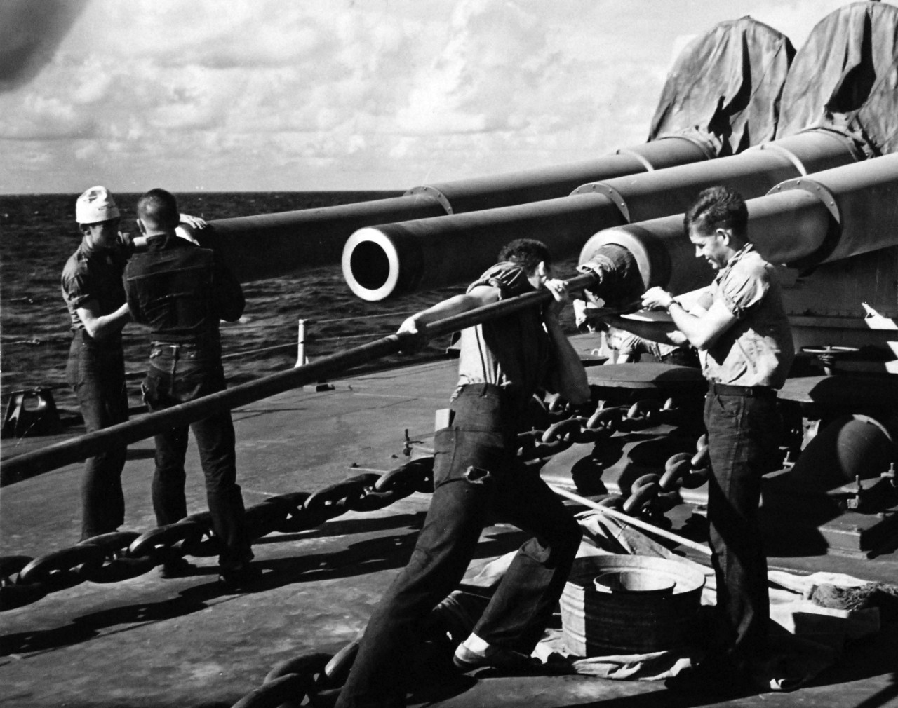 80-G-55347:  Wake Island Raid, October 5-6, 1943.     Cleaning the 8” guns of USS Minneapolis (CA 36) after the raid on Wake Island, October 5, 1943.  Photographed by CPU-7.  U.S. Navy photograph, now in the collections of the National Archives.    (2015/04/28).