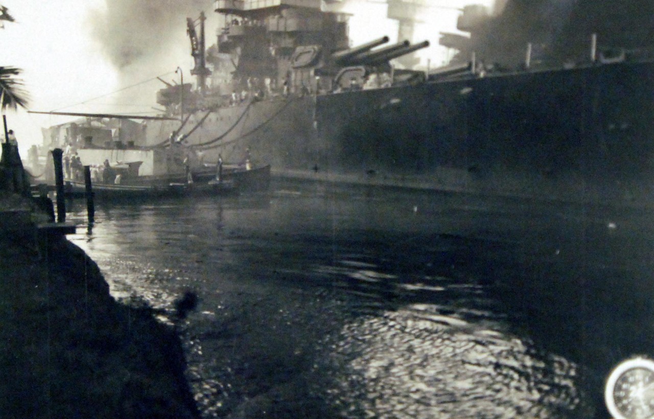80-G-32646:   Japanese Attack on Pearl Harbor, December 7, 1941.  USS Tennessee (BB 43), burning and damaged after the Japanese attack on Pearl Harbor, 7 December 1941.  Official U.S. Navy photograph, now in the collections of the National Archives.           (7/2/2014).