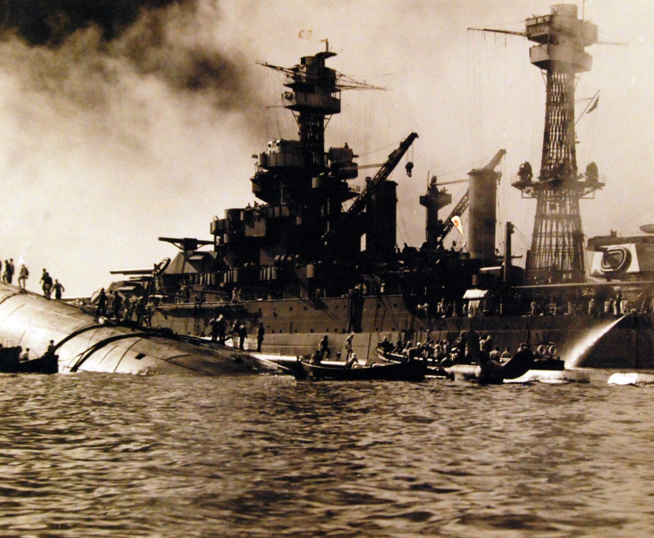 80-G-32748:   Japanese Attack on Pearl Harbor, December 7, 1941.   The capsized USS Oklahoma (BB 37) and USS Maryland (BB 46) are shown after the attack. Official U.S. Navy photograph, now in the collections of the National Archives. (9/9/2015).