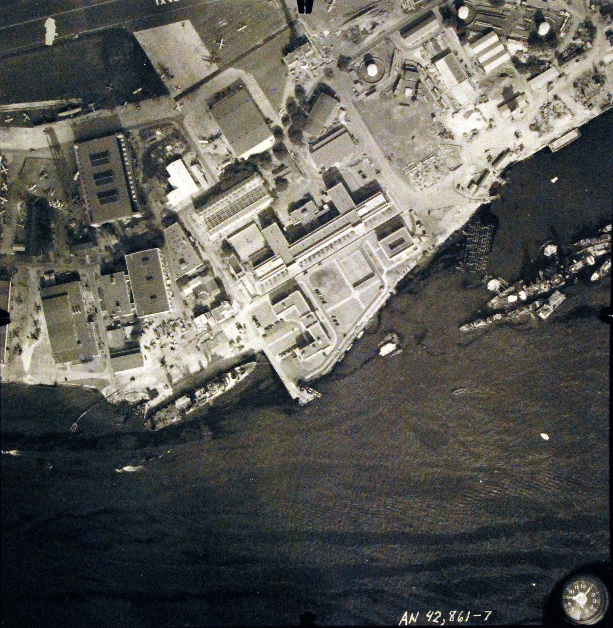 80-G-387568:  Pearl Harbor Attack, 7 December 1941.  Aerial view of "Battleship Row" moorings on the southern side of Ford Island, 10 December 1941, showing damage from the Japanese raid three days earlier.  USS California (BB 44) and USS Curtiss (AV 4) are shown.  Note dark oil streaks on the harbor surface, originating from the sunken battleships.  Photographed by VJ-1 at an altitude of 3,000 feet and released November 9, 1950. U.S. Navy photograph, now in the collections of the National Archives .   (9/22/2015).