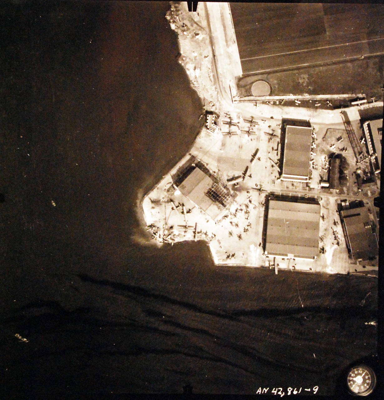 80-G-387570:  Pearl Harbor Attack, 7 December 1941.  Aerial view of Naval Air Station Ford Island taken three days after the attack on 10 December.  Photographed by VJ-1 at an altitude of 3,000 feet and released November 9, 1950.  U.S. Navy photograph, now in the collections of the National Archive.  s (9/22/2015).