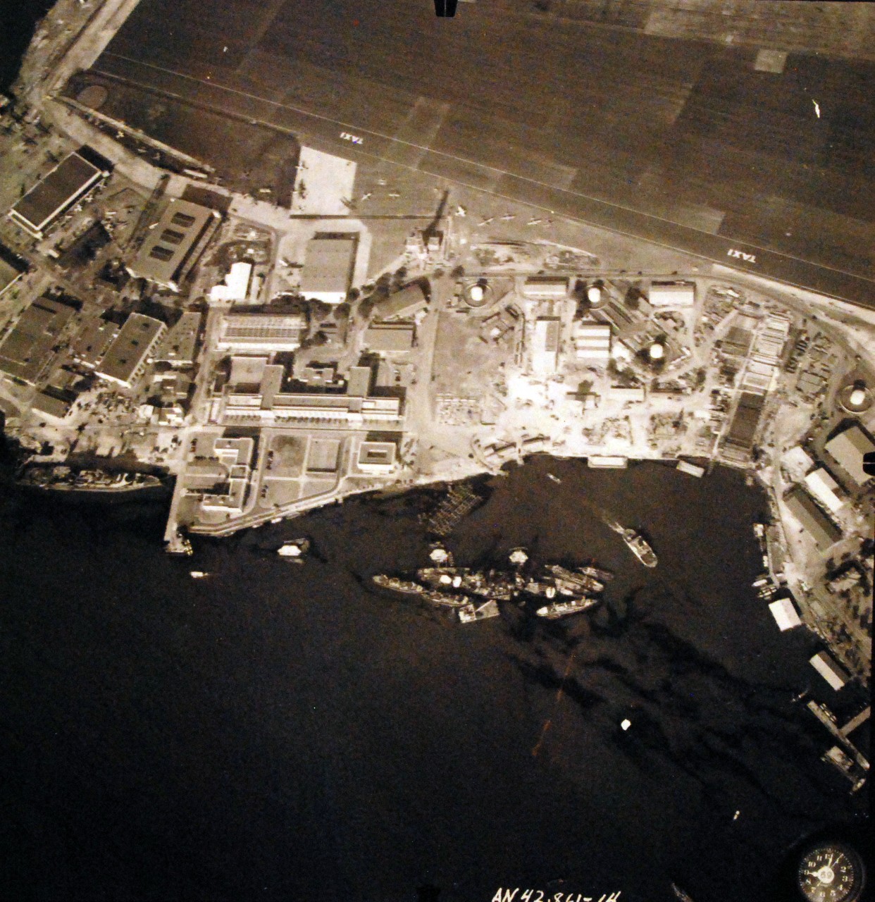 80-G-387575:  Pearl Harbor Attack, 7 December 1941.  Aerial view of "Battleship Row" moorings on the southern side of Ford Island, 10 December 1941, showing damage from the Japanese raid three days earlier.  USS California (BB 44) is shown.  Note dark oil streaks on the harbor surface, originating from the sunken battleships. Photographed by VJ-1 at an altitude of 3,000 feet and released November 9, 1950.  U.S. Navy photograph, now in the collections of the National Archives.      (9/22/2015).