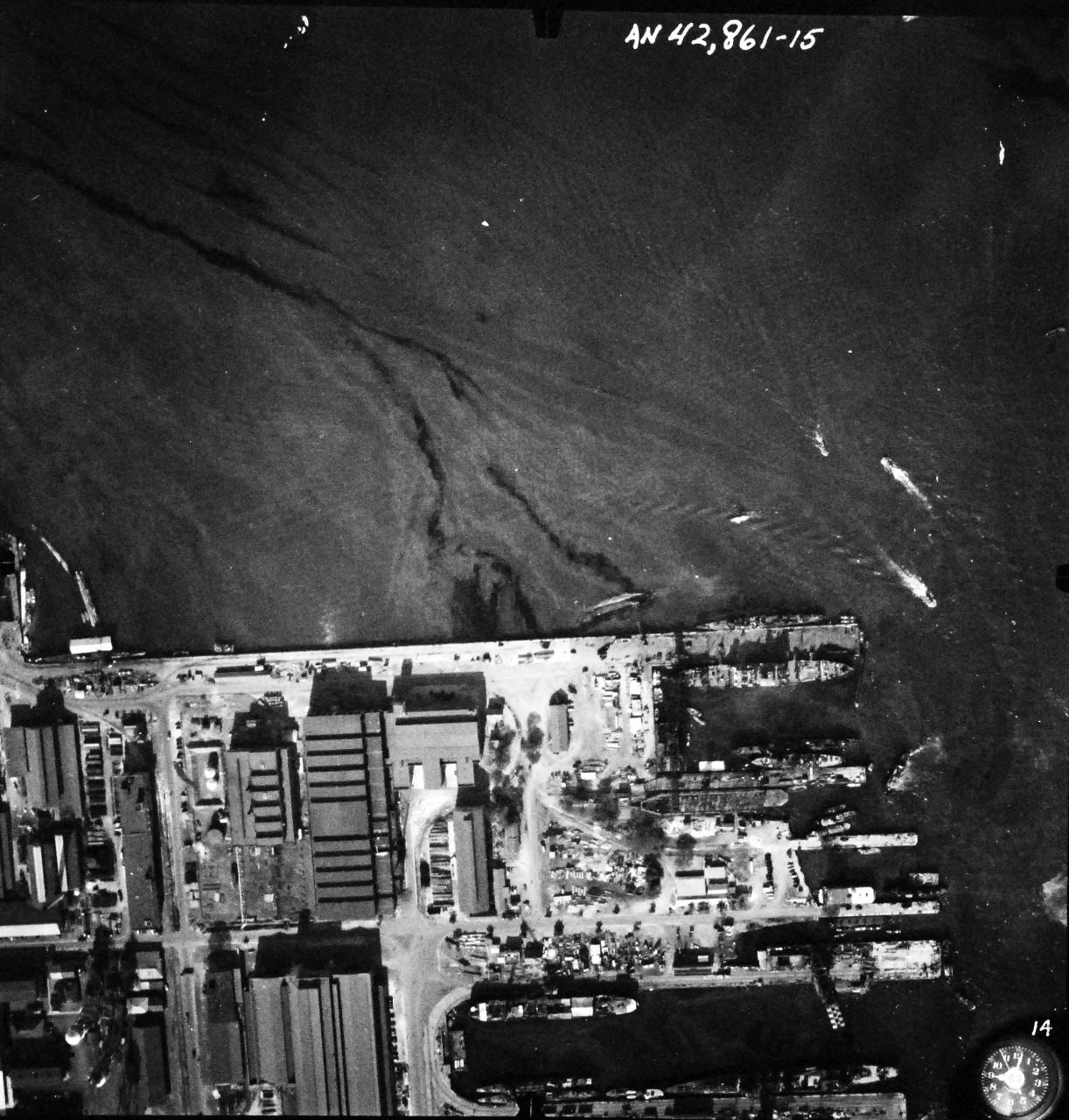 80-G-387577:  Pearl Harbor Attack, 7 December 1941.  Aerial view of "Battleship Row" moorings on the southern side of Ford Island, 10 December 1941, showing damage from the Japanese raid three days earlier.  Ships shown are, (right to left):  USS Pennsylvania (BB 38); USS Cassin (DD 372); USS Downes (DD 375); USS Helena (CL 50) and USS Shaw (DD 373).  Note dark oil streaks on the harbor surface, originating from the sunken battleships. Photographed by VJ-1 at an altitude of 3,000 feet and released November 9, 1950.  U.S. Navy photograph, now in the collections of the National Archives.     (9/22/2015).
