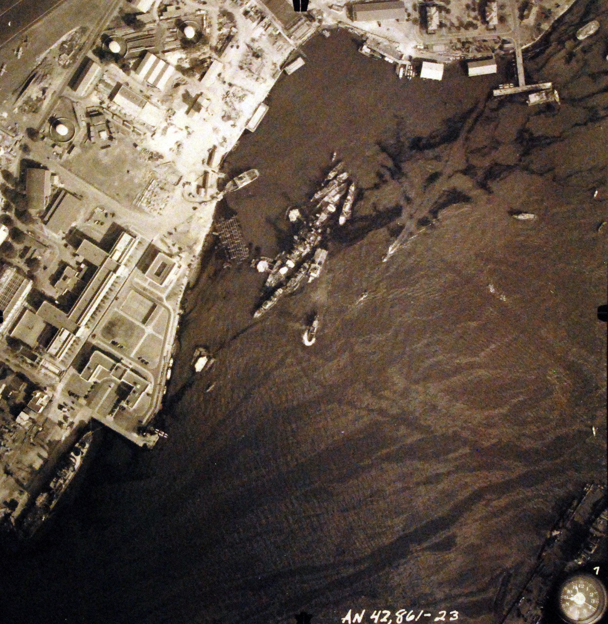 80-G-387584:  Pearl Harbor Attack, 7 December 1941.  Aerial view of "Battleship Row" moorings on the southern side of Ford Island, 10 December 1941, showing damage from the Japanese raid three days earlier.  USS California (BB 44) is shown.  Note dark oil streaks on the harbor surface, originating from the sunken battleships. Photographed by VJ-1 at an altitude of 3,000 feet and released November 9, 1950. U.S. Navy photograph, now in the collections of the National Archives.     (9/22/2015).
