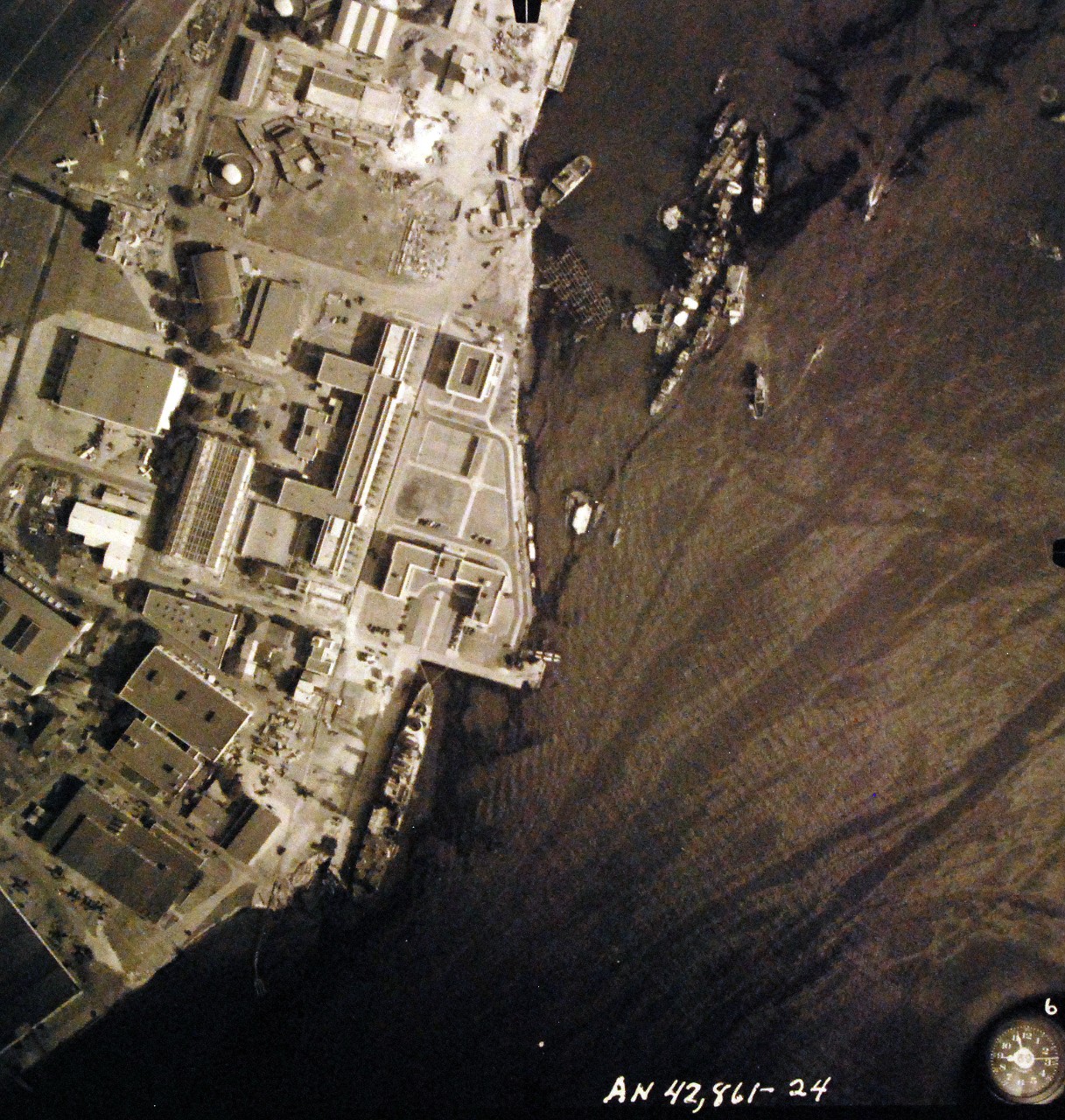 80-G-387585:  Pearl Harbor Attack, 7 December 1941.  Aerial view of "Battleship Row" moorings on the southern side of Ford Island, 10 December 1941, showing damage from the Japanese raid three days earlier.  Ships, (left to right), USS Curtiss (AV 4) and USS California (BB 44).  Note dark oil streaks on the harbor surface, originating from the sunken battleships.  Photographed by VJ-1 at an altitude of 3,000 feet and released November 9, 1950. U.S. Navy photograph, now in the collections of the National Archives.     (9/22/2015).