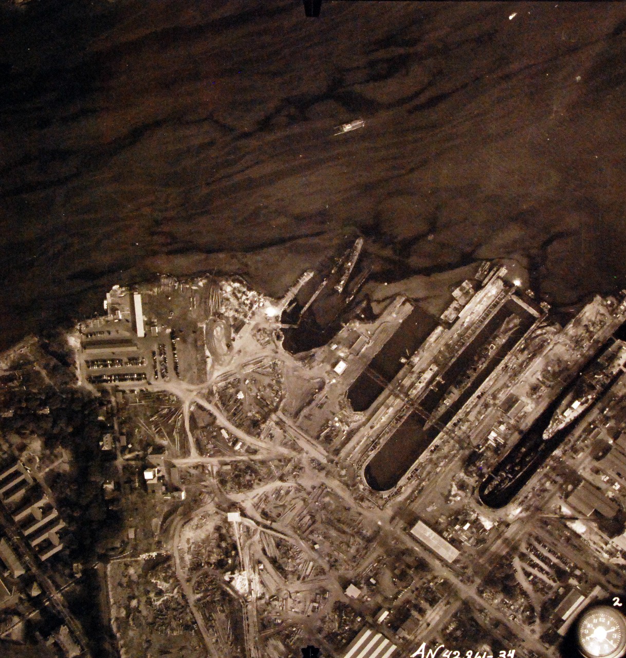 80-G-387594:  Pearl Harbor Attack, 7 December 1941.  Aerial view of "Battleship Row" moorings on the southern side of Ford Island, 10 December 1941, showing damage from the Japanese raid three days earlier.  Ships shown are, (right to left):  USS Pennsylvania (BB 38); USS Cassin (DD 372); USS Downes (DD 375); USS Helena (CL 50) and USS Shaw (DD 373).  Note dark oil streaks on the harbor surface, originating from the sunken battleships. Photographed by VJ-1 at an altitude of 3,000 feet and released November 9, 1950. U.S. Navy photograph, now in the collections of the National Archives.       (9/22/2015).
