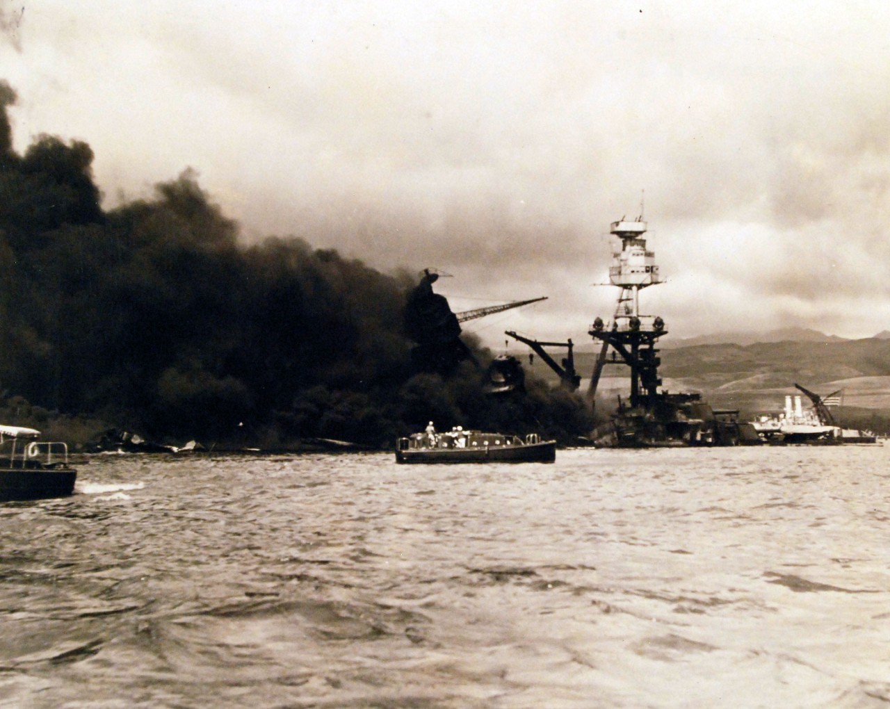 80-G-413513:  Pearl Harbor Attack, 7 December 1941.  USS Arizona (BB 39) during the attack. Note, the motor whale boat in the center of the photograph looking for survivors. U.S. Navy photograph, now in the collections of the National Archives.         (9/29/2015).