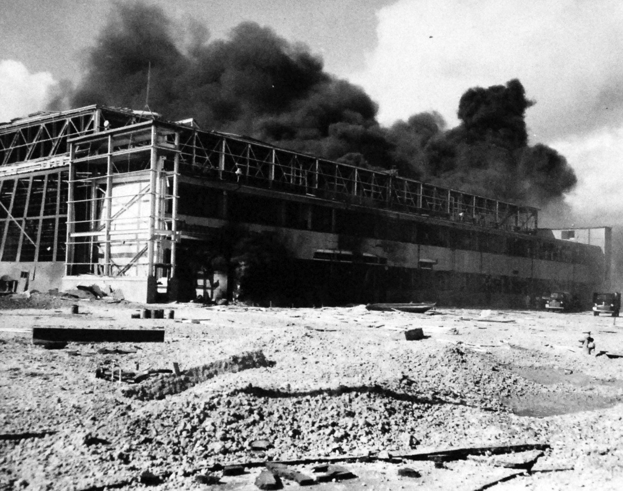 80-G-32841:  Japanese Attack on Pearl Harbor, December 7, 1941.   Hangar burning after Japanese attack.   KNOE 128. . Official U.S. Navy photograph, now in the collections of the National Archives.   (9/9/2015).