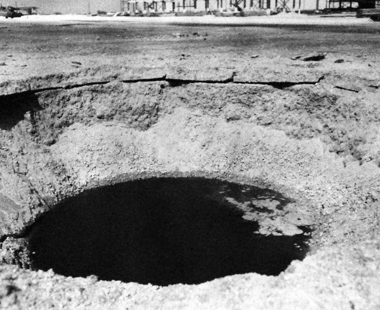 80-G-32846:  Japanese Attack on Pearl Harbor, December 7, 1941.   Bomb crater on apron at Hickham Field from the Japanese attack. . Official U.S. Navy photograph, now in the collections of the National Archives.  (9/9/2015).