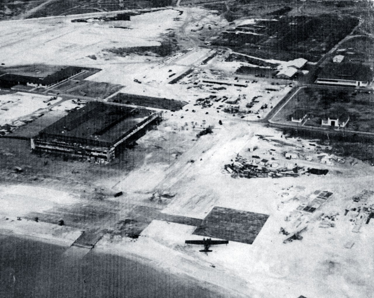 80-G-32866:   Half-tone image of a photograph, Japanese Attack on Pearl Harbor, December 7, 1941.  Hangar area at Naval Air Station, Kaneohe Bay, Territory of Hawaii, showing damage wrought by Japanese bombing.  Aerial view looks Northwest at an altitude of 700 feet.  (8/25/2015).