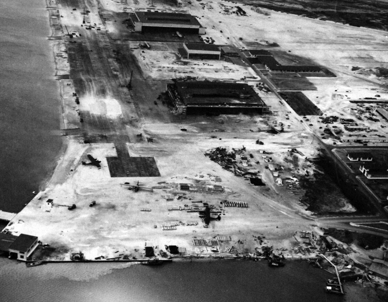 80-G-32867:   Japanese Attack on Pearl Harbor, December 7, 1941.   Hangar area at Naval Air Station, Kaneohe Bay showing damage wrought by the Japanese bombing.  The view looks west at an altitude of 500’.  Official U.S. Navy photograph, now in the collections of the National Archives.  (9//9/2015).
