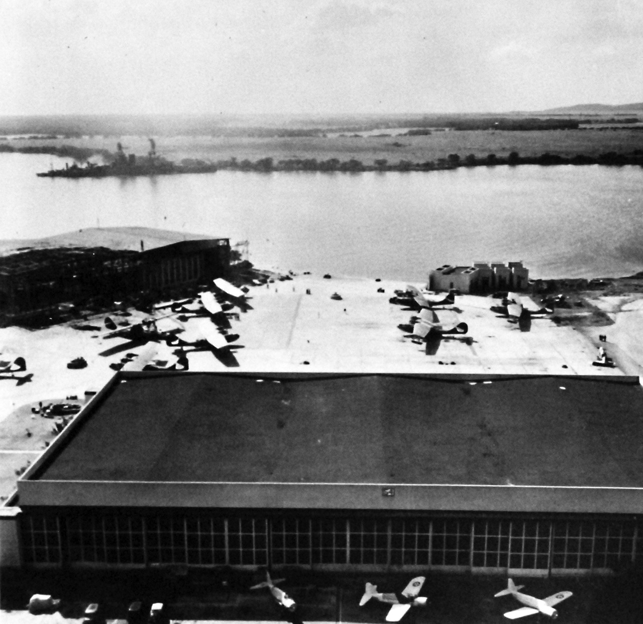 80-G-32926:  Japanese Attack on Pearl Harbor Attack, 7 December 1941.   Damaged planes and hangar at Pearl Harbor, Territory of Hawaii, after Japanese attack on 7 December 1941. U.S. Navy photograph, now in the collections of the National Archives.    (9/13/2013).