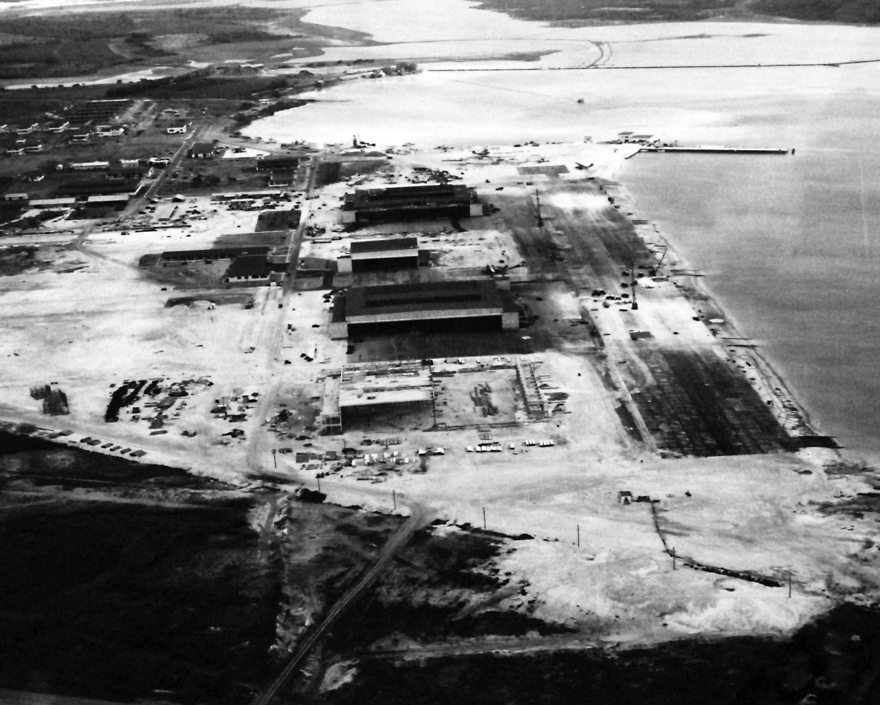 80-G-32942:   Japanese Attack on Pearl Harbor Attack, 7 December 1941.    Hangar area at Naval Air Station, Kaneohe Bay, Territory of Hawaii, showing wrought by Japanese bombing  View shows the area looking southeast. U.S. Navy photograph, now in the collections of the National Archives.     (9/13/2013).