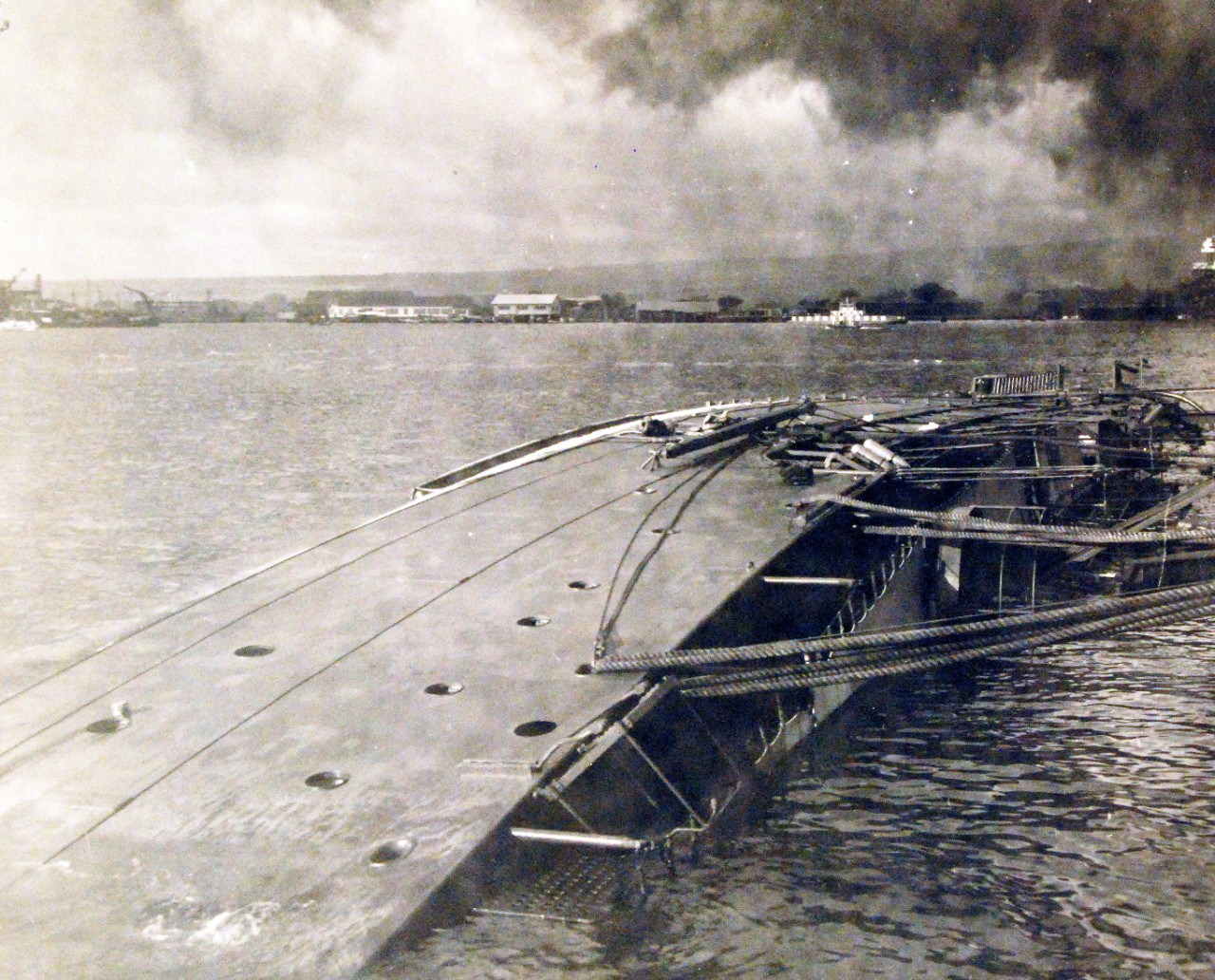 80-G-32532:  Japanese Attack on Pearl Harbor, December 7, 1941.  USS Oglaga (CM 4), capsized alongside 1010 dock at Pearl Harbor following the attack. Official U.S. Navy photograph, now in the collections of the National Archives.    (9/15/15).
