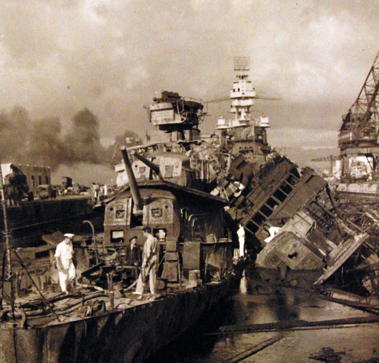 80-G-32763:   Japanese Attack on Pearl Harbor, December 7, 1941.  Wreckage of USS Cassin (DD 372) and USS Downes (DD 375) in Drydock Number 1.   USS Pennsylvania (BB 38) is in the background.  Official U.S. Navy photograph, now in the collections of the National Archives. (9/9/2015).