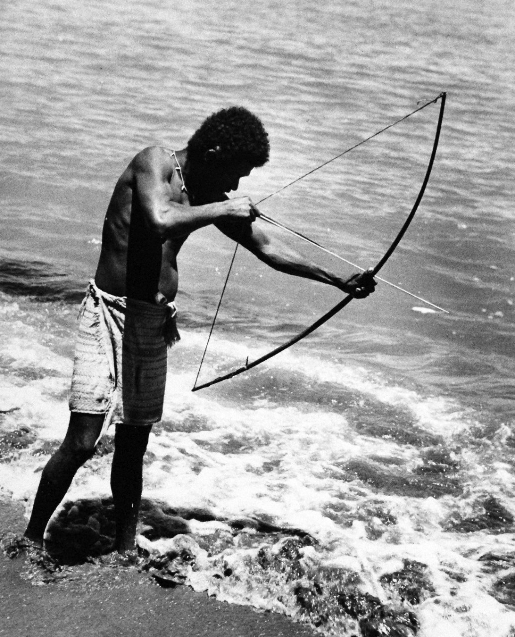 80-G-216094: Guadalcanal Island, Solomon Islands.  Bow and arrow is used by Solomon Island natives for fishing.  Note old towel used as loin cloth.  These fellows speak good English, are friendly and have saved many American pilot’s lives.  They fed and cared for injured pilots and took many a Navy flier through Japanese lines to safety during the Battle of Guadalcanal.  Photograph released February 6, 1944.  U.S. Navy Photograph, now in the collections of the National Archives.  (2016/11/25).