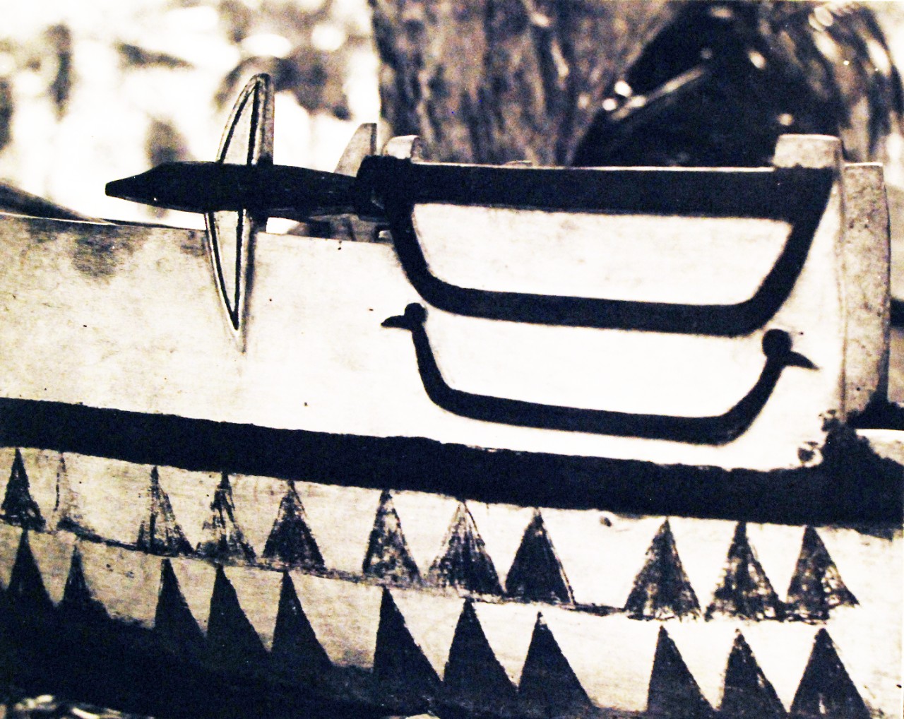 80-G-216095: Guadalcanal Island, Solomon Islands.  Native designs on prow of war canoe use motif of flying fish and triangles symbolizing sun pattern.  These designs are distinctive of Malaita, the most populated of the Solomon Islands.  It was in canoes like this that many navy pilots were rescued by natives during early days of the Battle of Guadalcanal.  Photograph released February 6, 1944.  U.S. Navy Photograph, now in the collections of the National Archives.  (2016/11/25).
