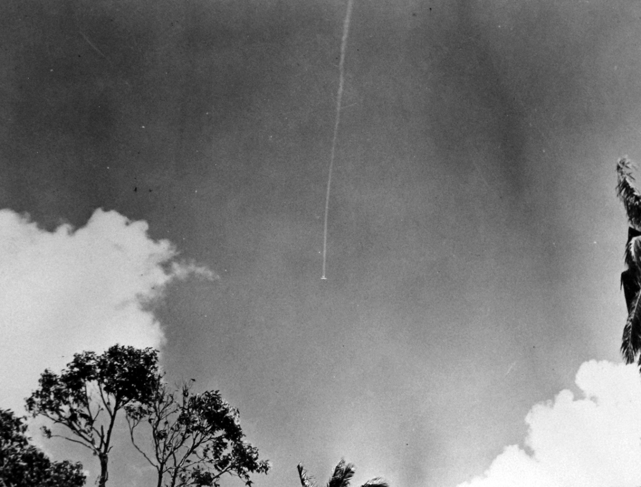 LC-Lot-801-22:  Guadalcanal Campaign, August 1942 – February 1943.  A thin plume of smoke marking the death plunge of a Japanese bomber, shot down by a U.S. Marine fighter plane over Guadalcanal in the early stages of fighting for the Solomon Islands.   Shortly after this picture was taken the plane crashed and exploded.   U.S. Navy Photograph.  Photographed through Mylar sleeve.  Courtesy of the Library of Congress. (2015/11/06).