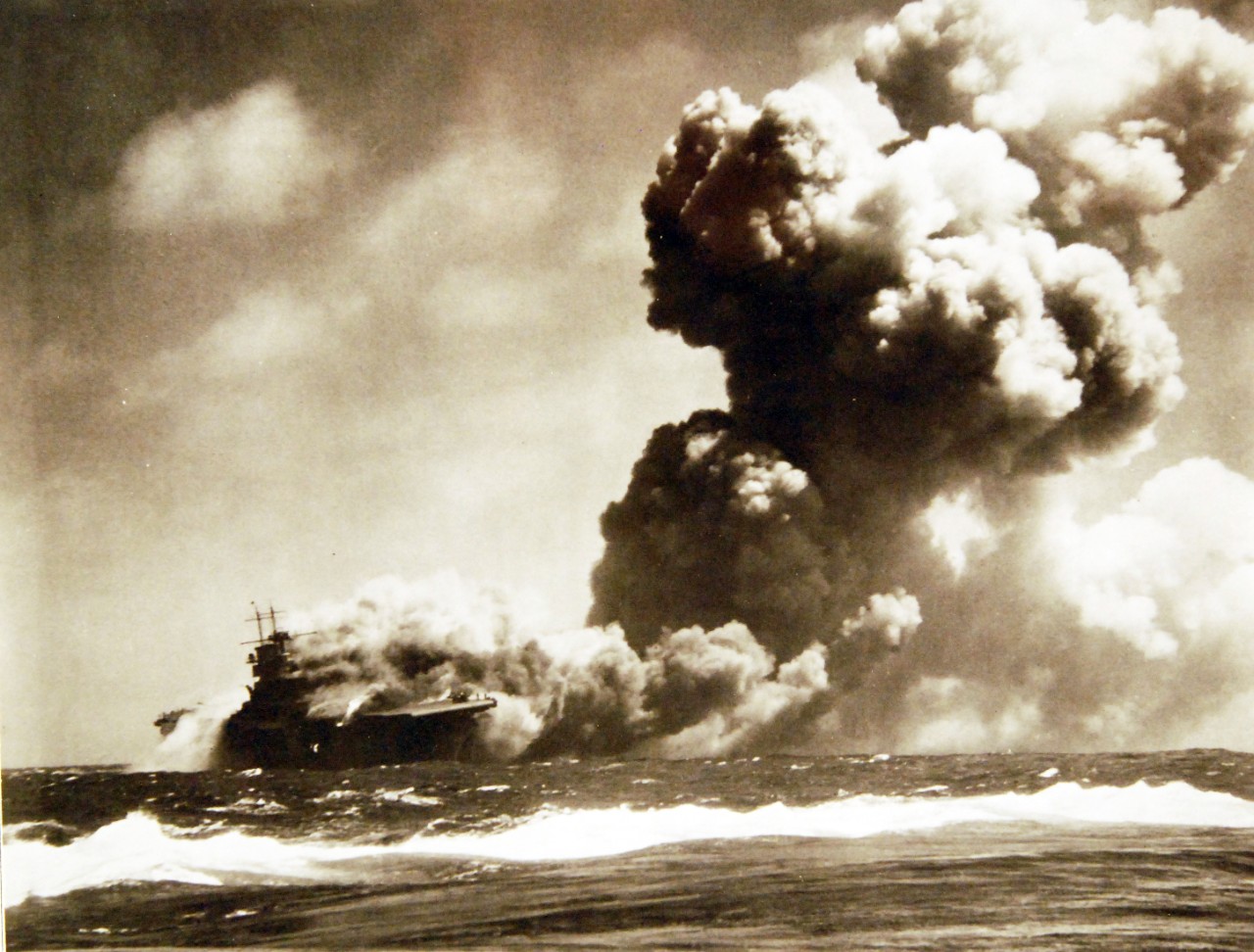 80-G-425072: Loss of USS Wasp (CV-7), 15 September 1942.    USS Wasp (CV-7) Burning and listing after she was torpedoed by the Japanese submarine I-19, on 15 September 1942, while operating in the Southwestern Pacific in support of forces on Guadalcanal.     Official U.S. Navy Photograph, now in the collections of the National Archives.   (2017/08/01).  