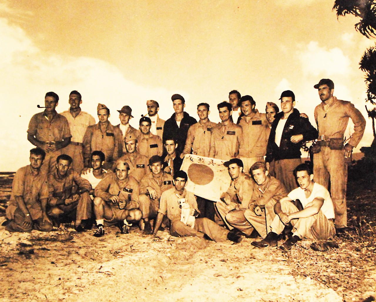 80-G-40892:    “The Cactus Airforce.”   Marine Aviation Squadrons involved in Guadalcanal Battles.  Front row, kneeling and sitting, left to right:  First Lieutenant S.K. Ottesen; First Lieutenant A. Christoperson; First Lieutenant C.E. McCullach; Second Lieutenant Augustus L. Arndt; First Lieutenant Jack Cosley; Second Lieutenant H. S. White; First Lieutenant A.L. Jones; First Lieutenant D.L. Cummings; Stinko, the mascot; Captain H.G. Schlendering; First Lieutenant H.E. Cook; and First Lieutenant R.O. Brown.   Back row, standing:   Second Lieutenant James A. Sullivan; First Lieutenant W.P. Mitchell; First Lieutenant E. P. Thompson; Second Lieutenant T. N. Withrow; First Lieutenant J.A. Etheridge; First Lieutenant Allen Ringblon; Captain Leon M. Williamson; First Lieutenant G.E. Lumpkin Lieutenant J.R. Blain; Second Lieutenant John E. Hays; Second Lieutenant W.J.F. Hacker; First Lieutenant R.D. Bachtel; First Lieutenant George Koutelas; and Second Lieutenant Howard Frazer,  March 16, 1943.   U.S. Navy  Official U.S. Navy Photograph, now in the collections of the National Archives.  (2016/12/20).
