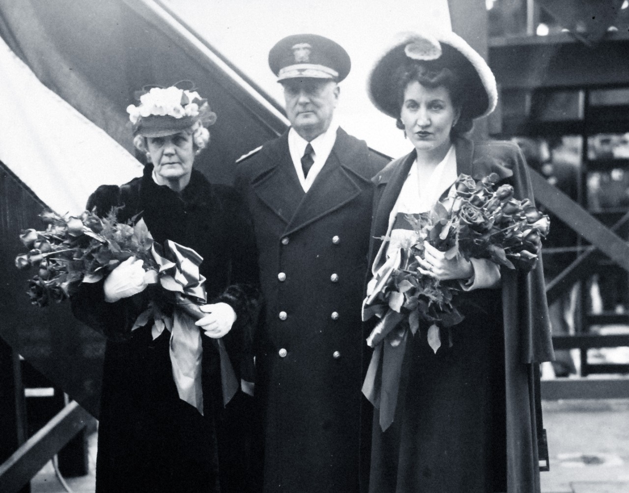 80-G-62015:  Mrs. James A. Dempsey, Ship’s Sponsor of USS Dempsey (DE 26), (left), Rear Admiral Robert A. Theobald, USN, (center), and Mrs. Mary Wintle, Ship’s Sponsor of USS Wintle (DE 25), (right), at the Boston Navy Yard, Boston, Massachusetts, for the christening and launching of both destroyer escorts on April 22, 1943. Wintle was named after Lieutenant Commander Jack W. Wintle who was killed on board USS San Francisco (CA 38) during the Naval Battle of Guadalcanal in November 1942.  Official U.S. Navy Photograph, now in the collections of the National Archives.     (2015/10/06).