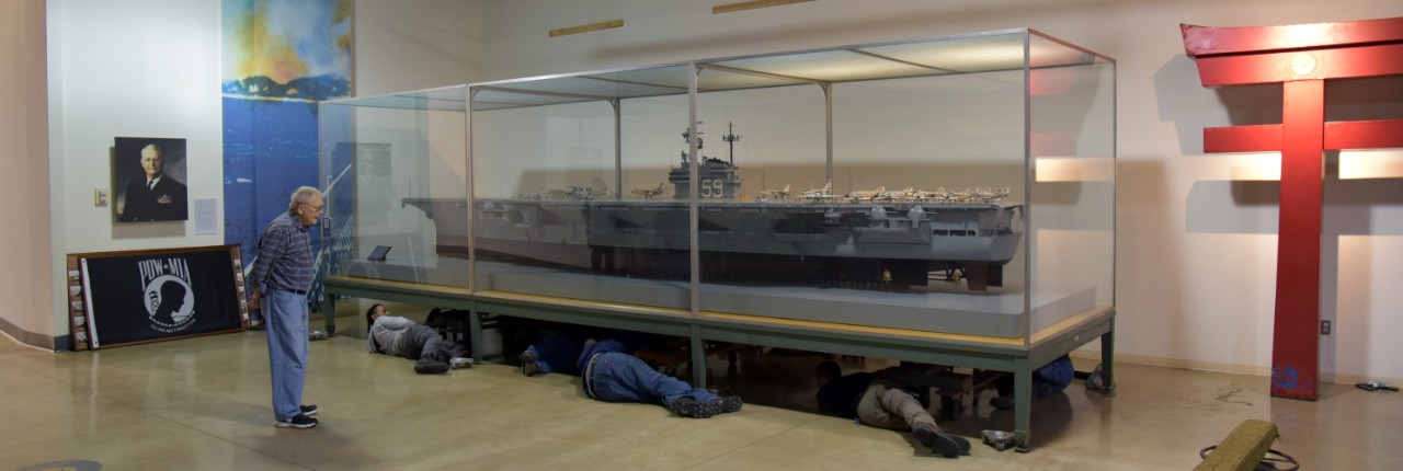 NMUSN-5105: Curator of Ship Models Dana Wegner observes his staff prepare for the move of the USS Forrestal (CVA-59) ship model from the Cold War Gallery, Bldg. 70, to the National Museum of the U.S. Navy, Bldg. 76), April 10, 2023. Official Nati...