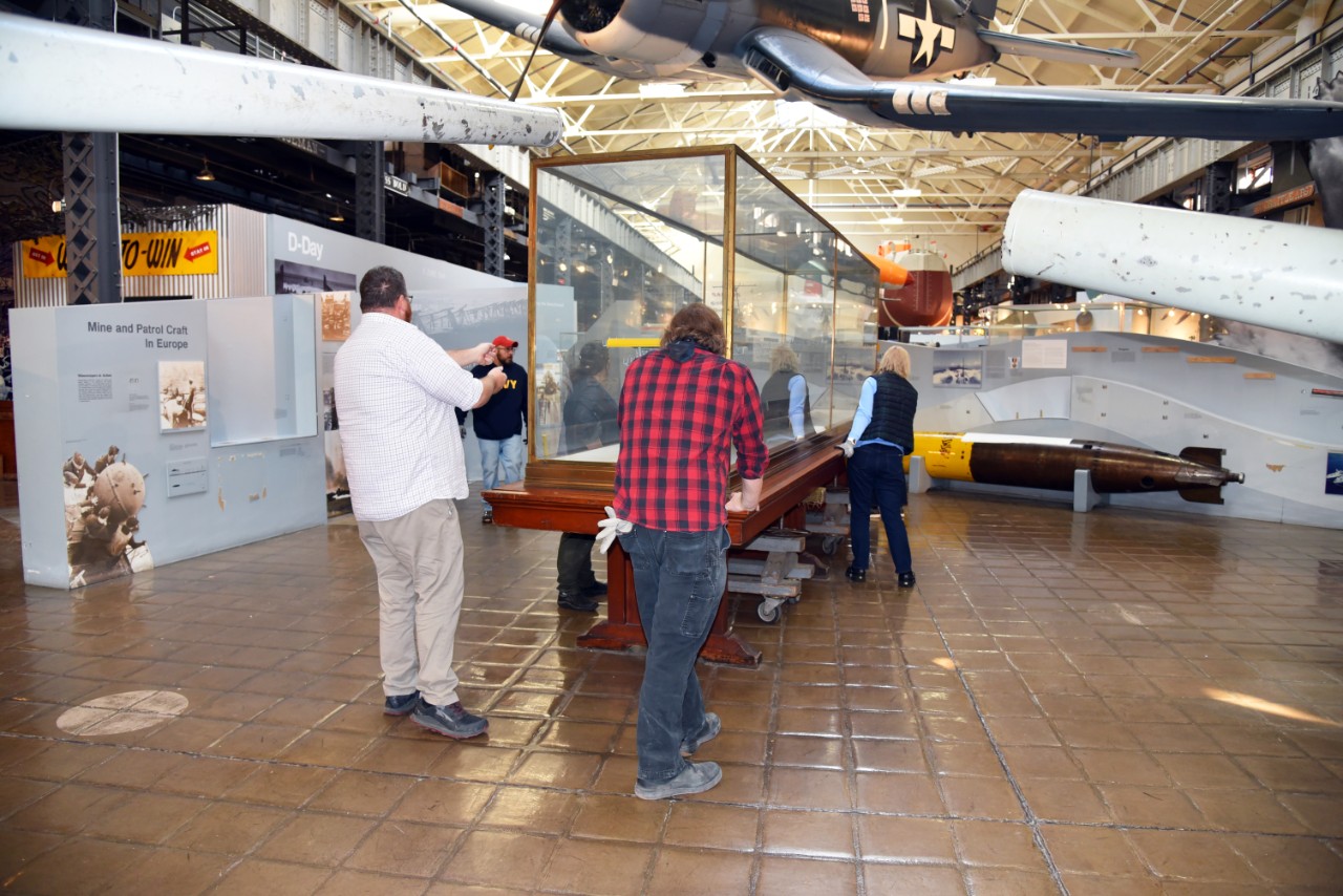NMUSN-5147: USS Ranger (CV-4), Model, November 2022. National Museum of the U.S. Navy staff, along with staff from the Naval Surface Warfare Center, Carderock Division, remove the model from its display area and carefully maneuver the model to th...