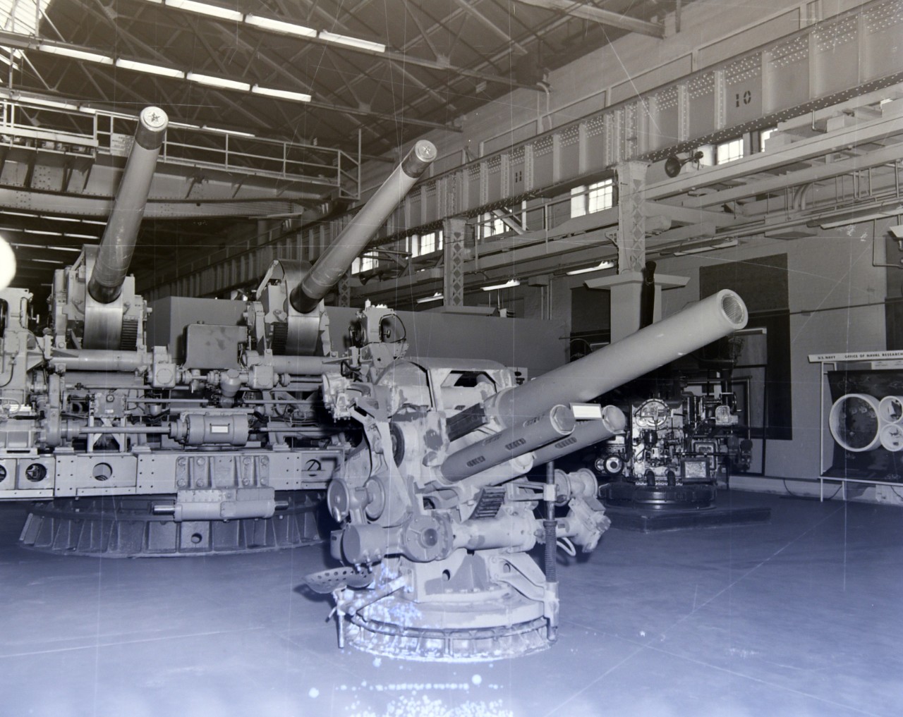NMUSN-1370: Weapons Display area, 1970s. 5” inch submarine gun along with the 5” .38 twin caliber gun on display. Original is a negative. National Museum of the U.S. Navy Photograph Collection