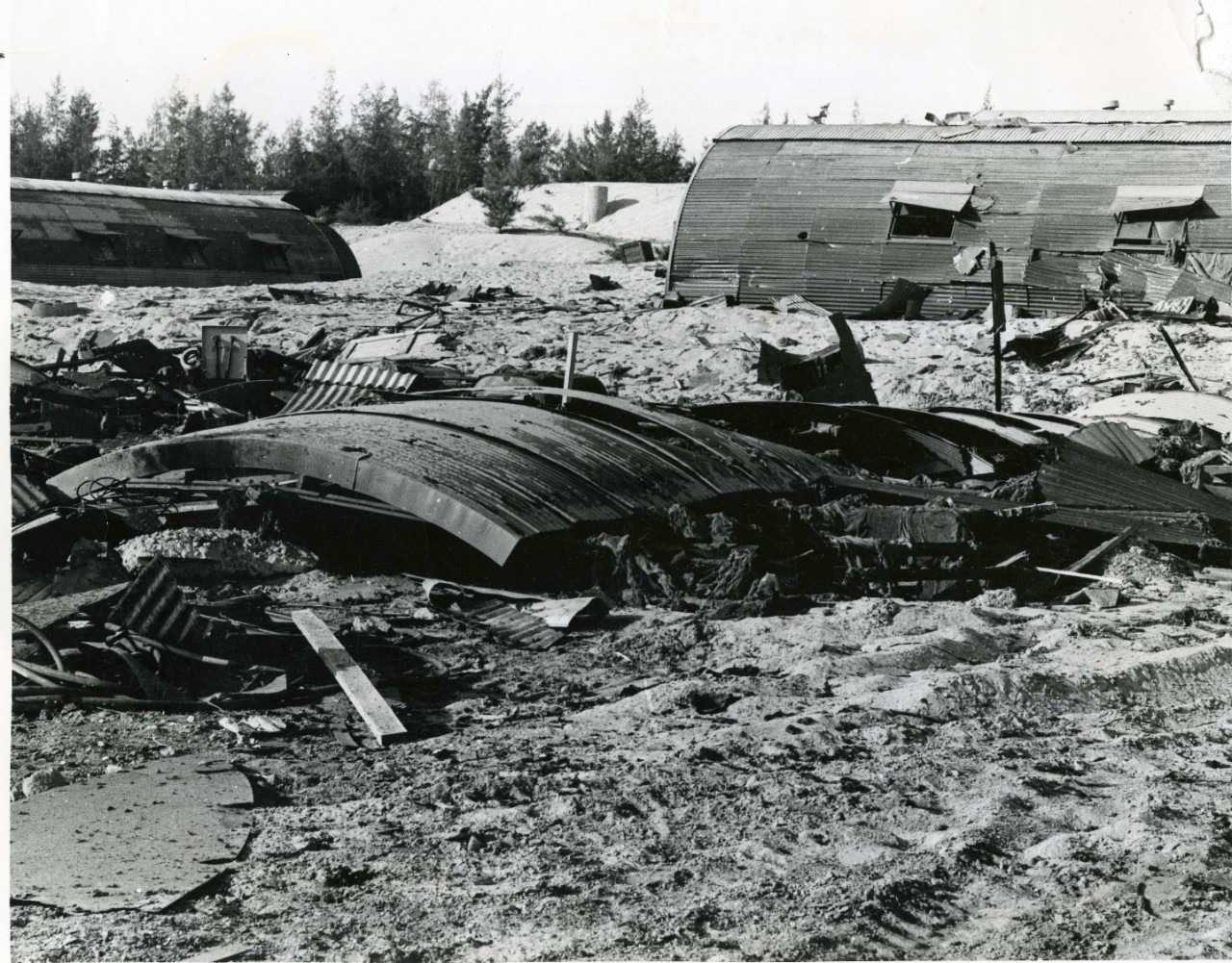 Destruction endured to Naval Quonset huts on Da Nang (Đà Nẵng), Vietnam after a Viet Cong San attack on 28 October, 1965. The area was later called Camp Adenir after the death of SD3 Restituto P. Adenir.