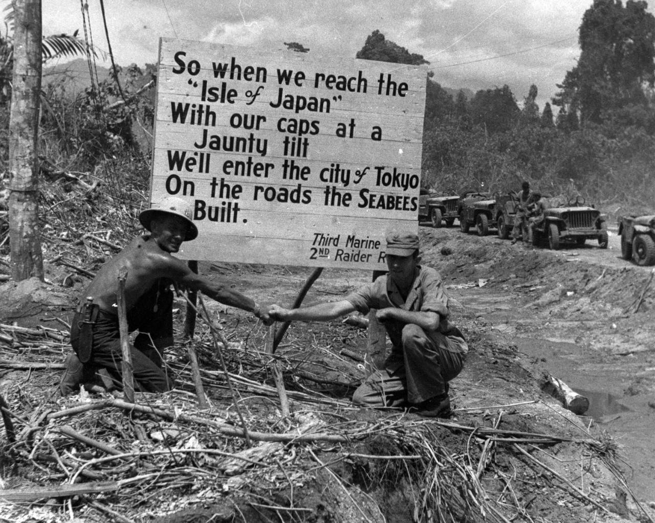 Seabees posed before sign, WWII
