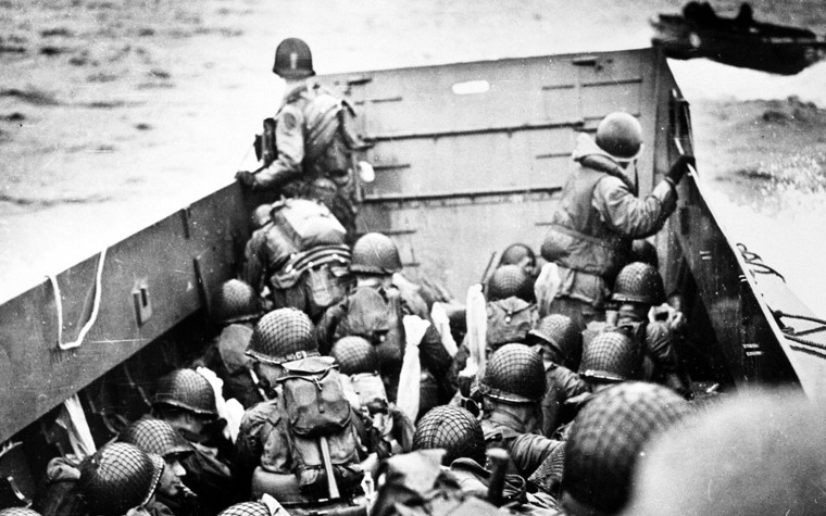 At dawn on 6 June 1944, nearly 7,000 U.S. and British ships and craft carrying close to 160,000 troops headed toward the Normandy beaches, surprising German forces. 