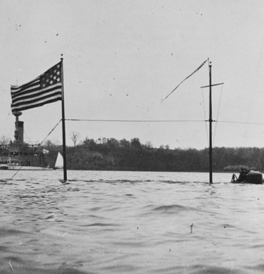 USS Holland (Submarine Torpedo Boat # 1) partially submerged off the U.S. Naval Academy, Annapolis, Maryland, in the summer of 1901. (NH 63088)