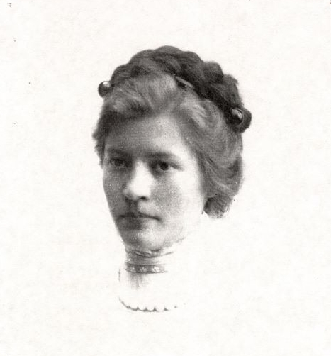 portrait of a woman wearing a white dress with a high neckline 