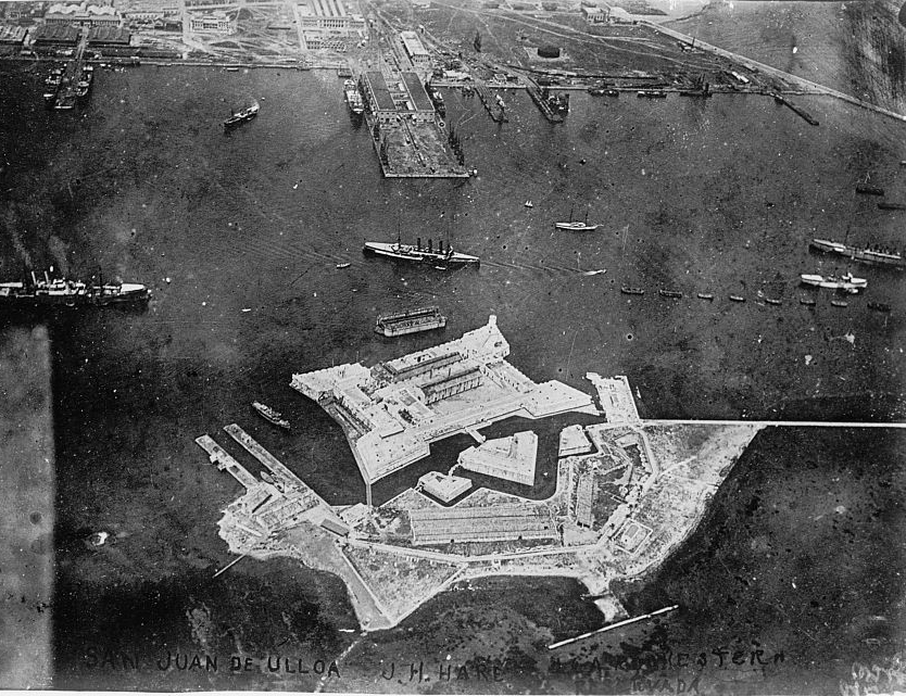Aerial view of a white fortress built in front of a harbor and shoreline.