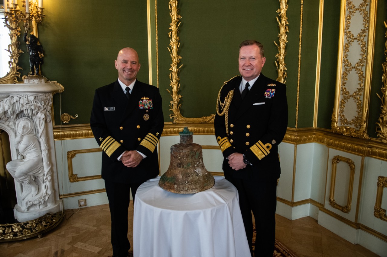 Adm. Jim Kilby, vice chief of naval operations and U.K. U.K. Vice Adm. Martin Connell, second sea lord and deputy chief of naval staff, with the ship’s bell of USS Jacob Jones (DD 61)