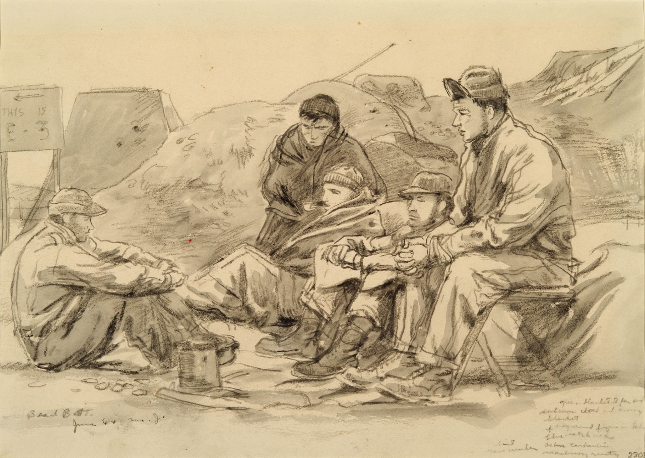 Men gather around a fire