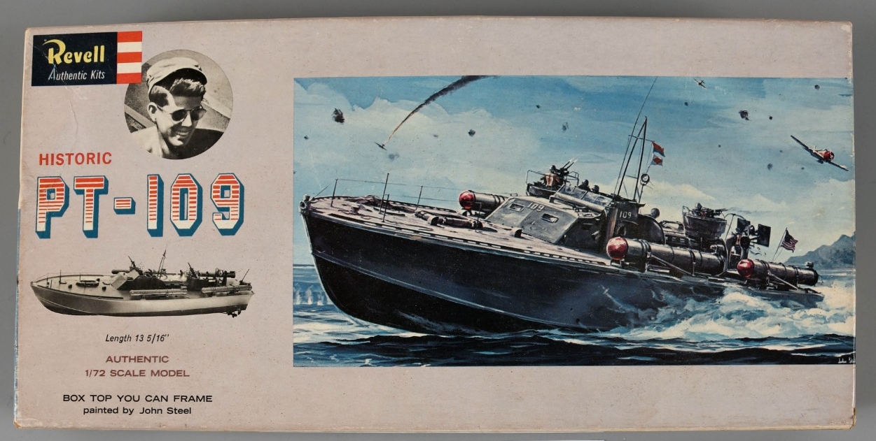 Cardboard box lid for PT-109 model kit. Lid contians full-color painting of PT-109 at sea, in the heat of battle. Small image of John F. Kennedy to the left and a black and white image of the complete model.