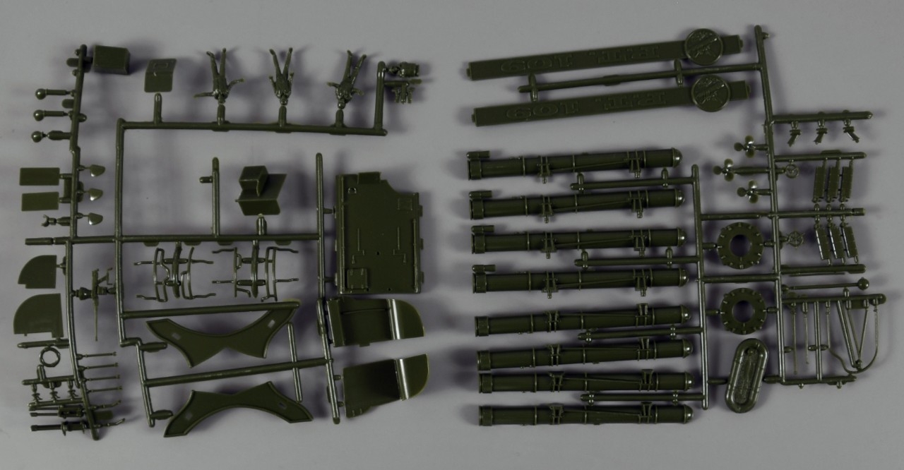 Selection of dark green model parts attached to plastic framework.