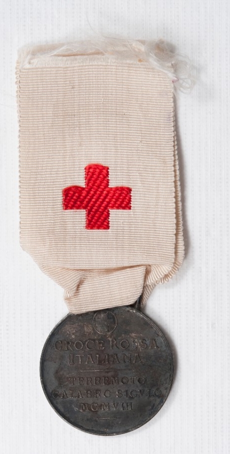 One white ribbon and red cross with a medallion marking Earthquake Relief in Italy 1909 Reverse of Medal