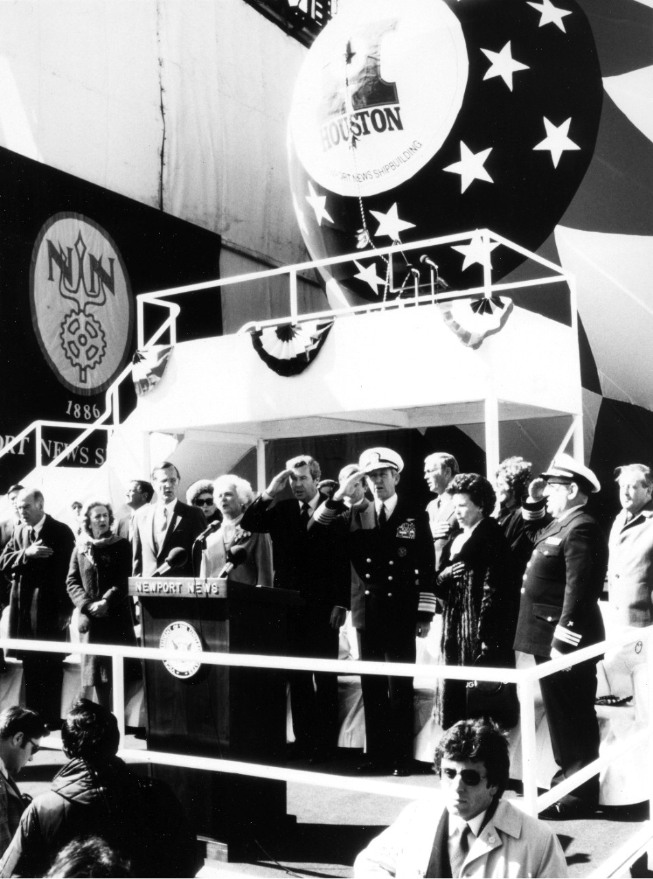 Newport News - the guests of honor stand during the playing of the National Anthem at the launching of the nuclear powered attack submarine USS Houston (SSN-713). The guests are from right to left: CDR Norman A. Ricard, Chaplain, Mrs. Hayward, ADM Thomas B. Hayward, Chief of Naval Operations, Edward Campbell, President of Newport News Shipbuilding, Mrs. Barbara Bush, Sponsor, Vice President George Bush, and Mrs. Potter Steward, Matron of Honor. March 21, 1981