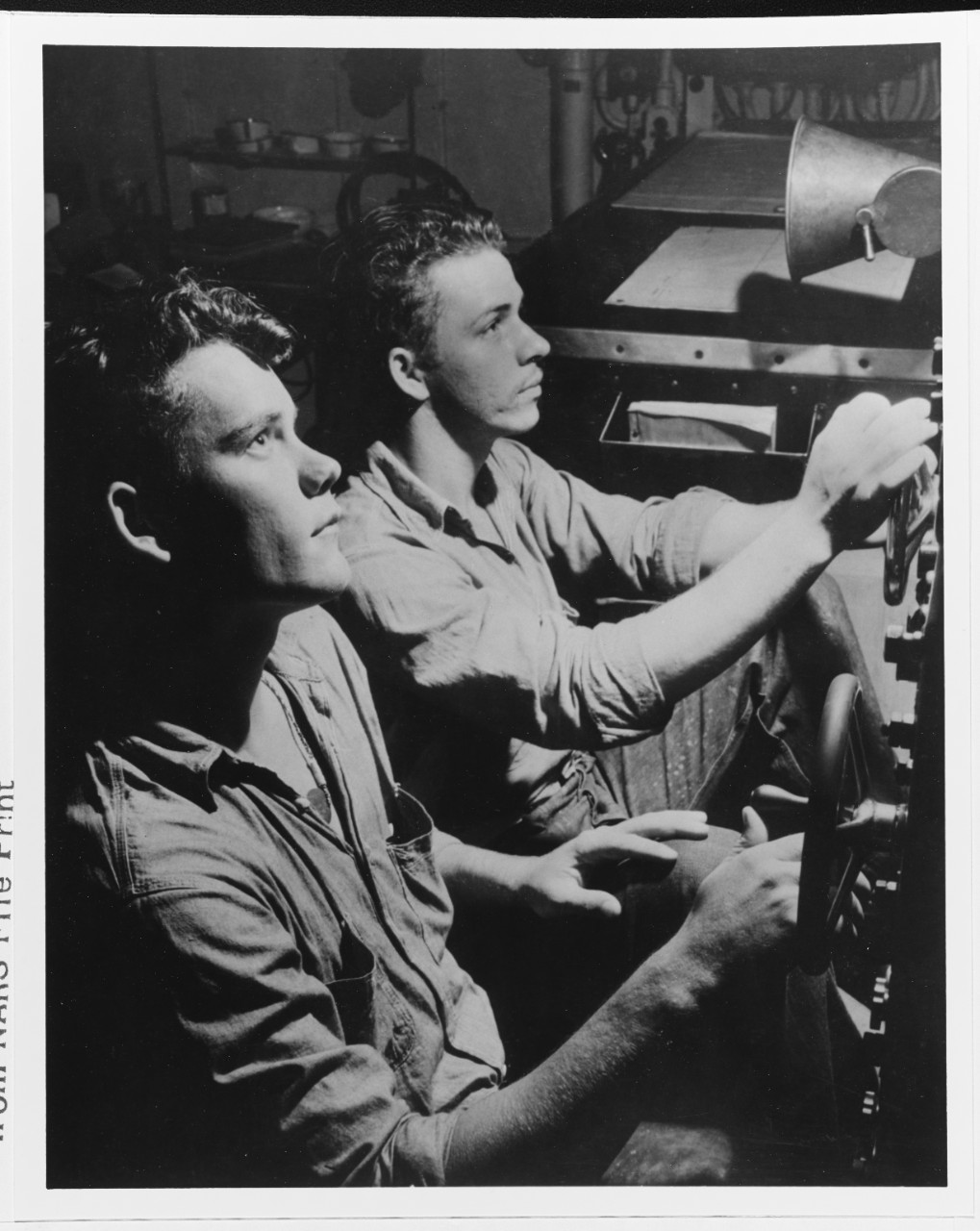 Crewmen Morton Herman and Oswald Pawekkobf watch the "OC" during a submarine chase on 9-10 May, 1942.  Original caption states: "this instrument detects submarines in a manner probably unknown to the enemy". 