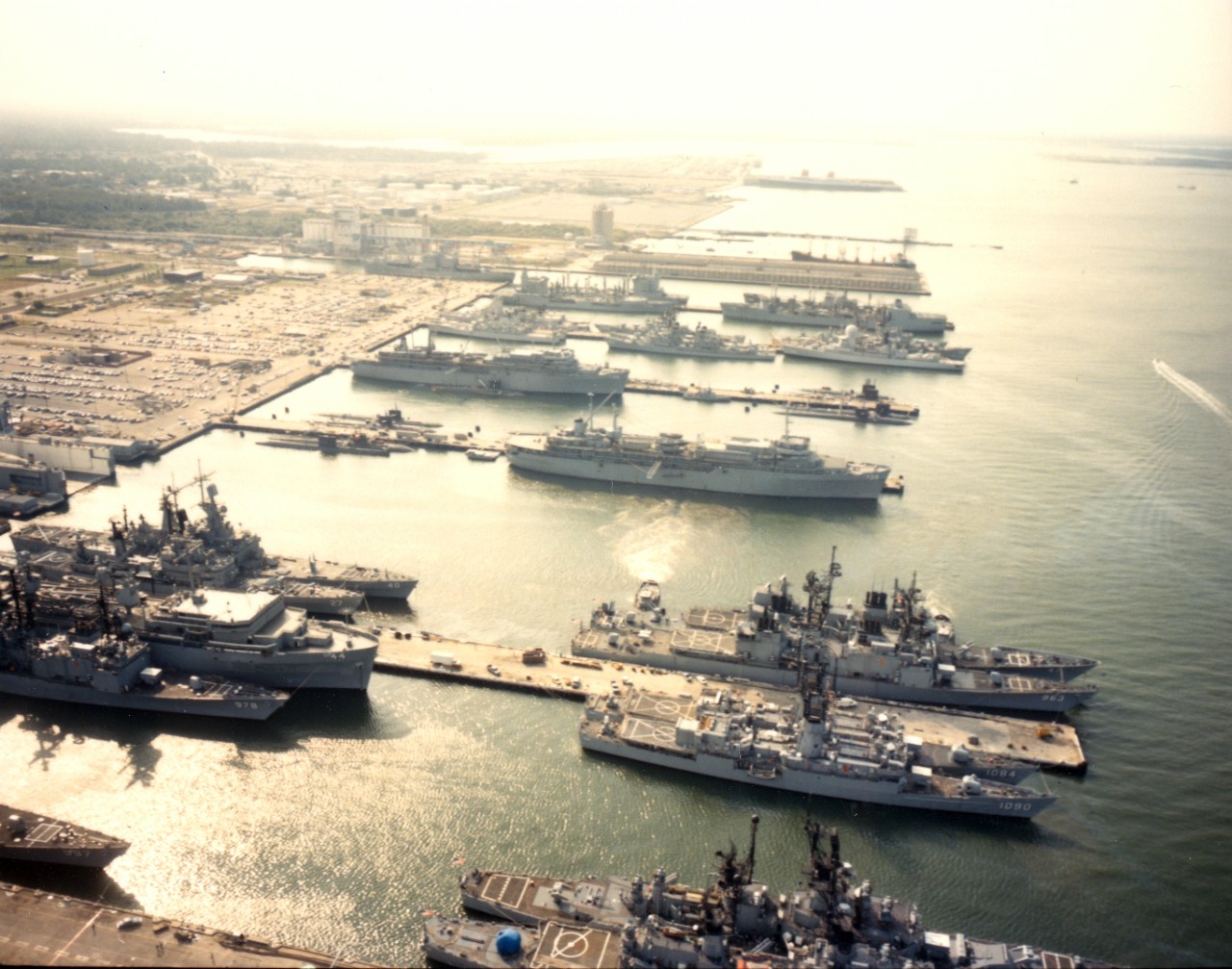 Naval Station, Norfolk, VA - an aerial view of the destroyer and submarine piers (Nos. 22 and 23) with various ships at anchor, including destroyers, frigates, cruisers, destroyers and submarine tenders and submarines. October 1984. 