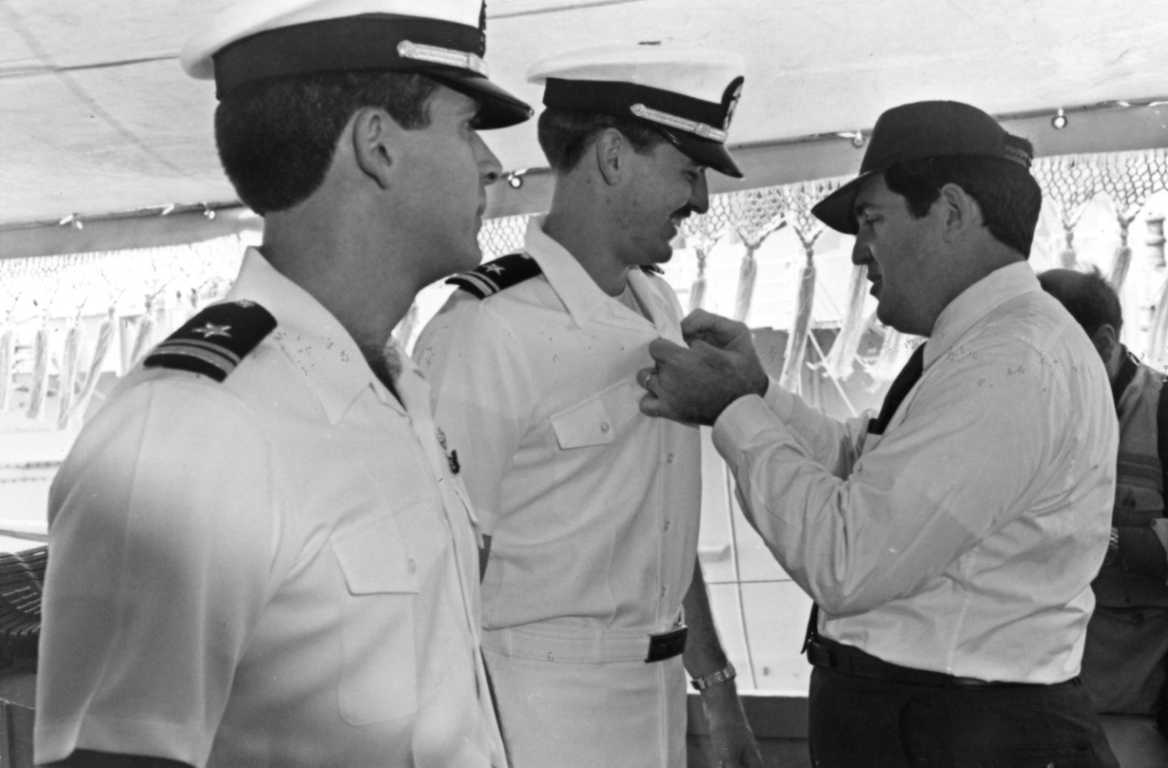 <p>Secretary of the Navy William L. Ball III pins surface warfare insignia on two officers during a ceremony on board destroyer USS John Hancock (DD-981).&nbsp;Ball is meeting with members of the Joint Task Force Middle East during his visit to the Persian Gulf.&nbsp;</p>
