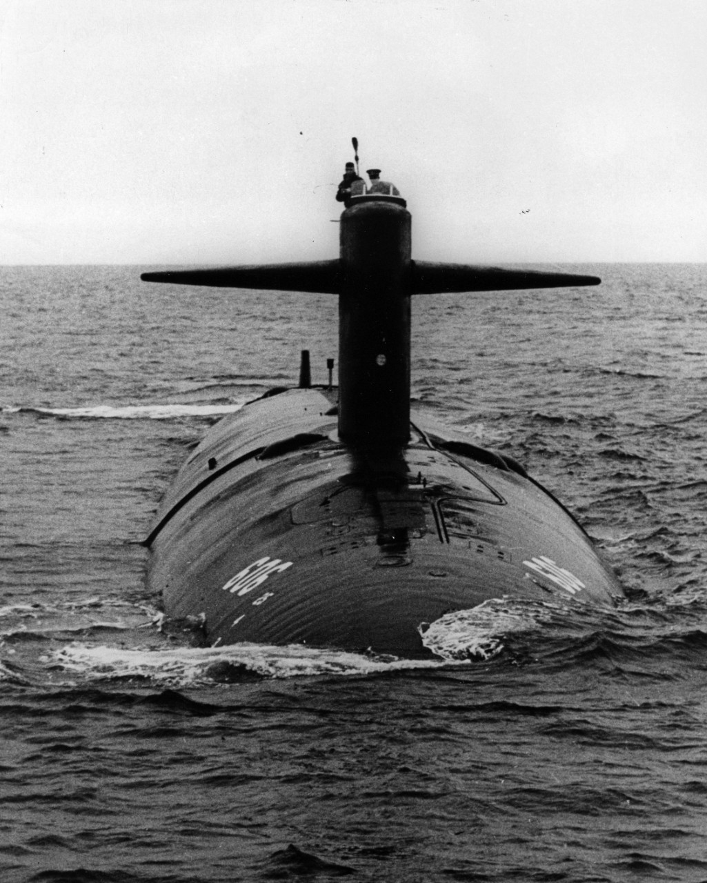 Bow view of nuclear powered attack submarine USS Tinosa (SSN-606) underway on the surface, September 1964