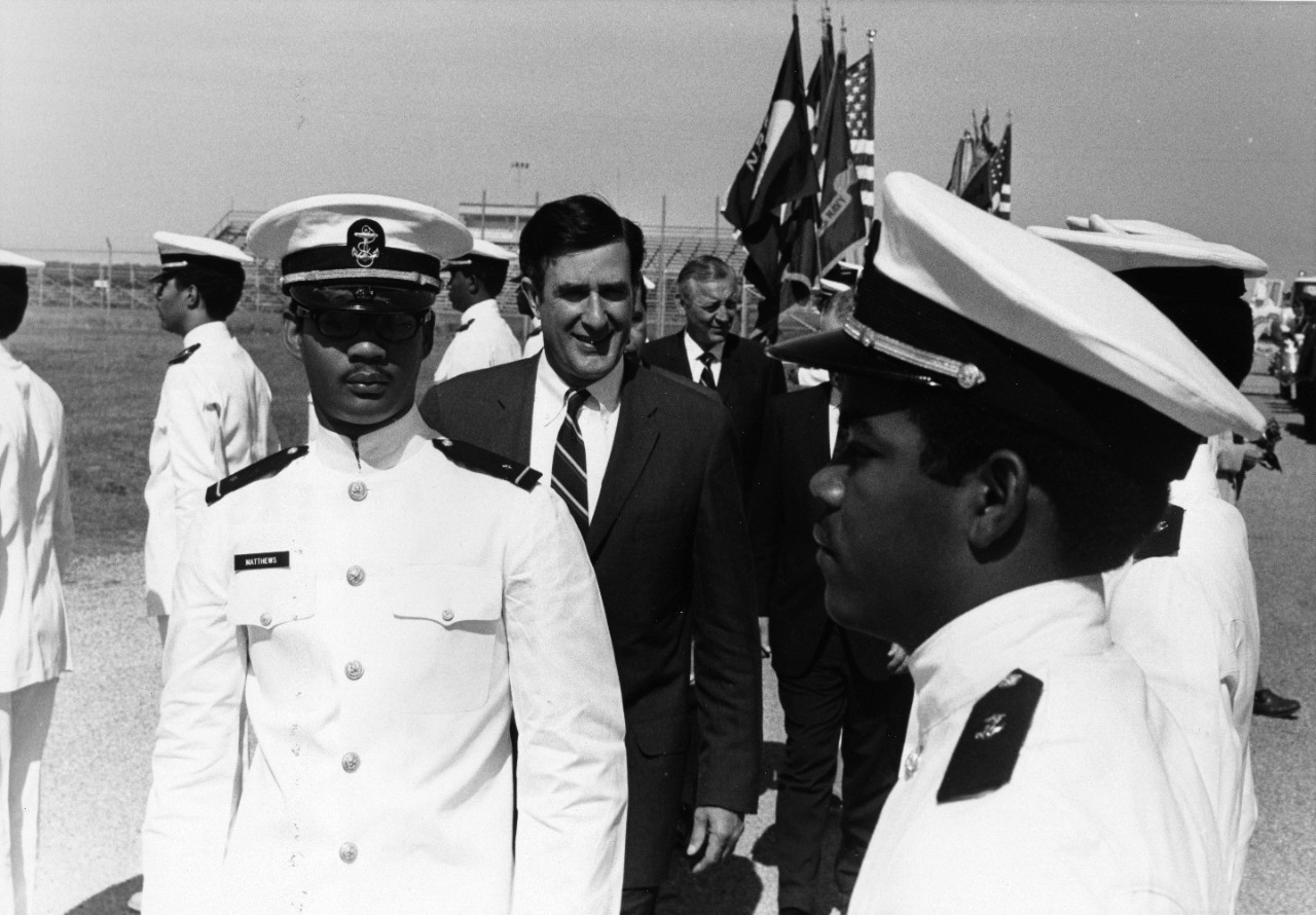 Secretary of the Navy John H. Chafee inspects the corps of midshipmen of the Naval Reserve Officer Training Corps at Prairie View A & M College in 1970. Secretary Chafee was the commencement speaker and administered the commissioning oath to the thirteen members of the first graduating class from the college.