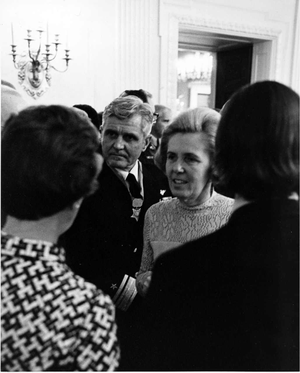 <p>RADM and Mrs. James B. Stockdale, center, chat with guests following the Medal of Honor ceremony in the East Room of the White House. Stockdale wears the medal awarded to him by President Gerald R. Ford during the ceremony. March 4, 1976.</p>
