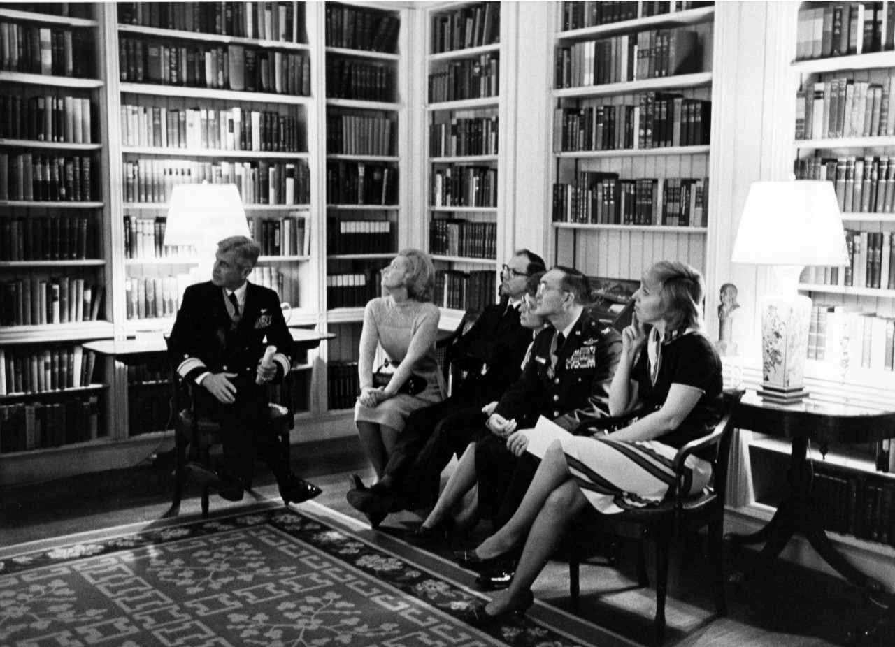 <p>Medal of Honor recipients RADM James B. Stockdale, left, and Air Force COL George E. Day, second from right, sit with members of their families and friends in a library of the White House. The award ceremony was held in the East Room of the mansion. March 4, 1976.</p>