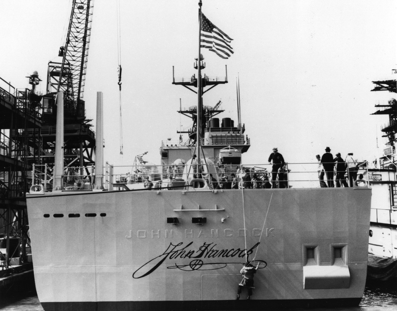 A sailor applies the finishing touches to America's most famous signature, to identify the destroyer USS John Hancock (DD-981), prior to commissioning. 