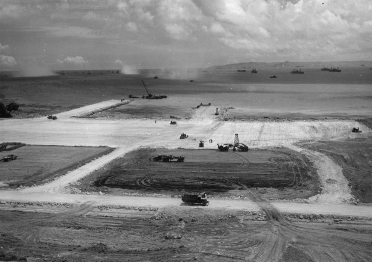 A view of the seaplane base showing apron and two causeways under construction at Okinawa. Coral was used in the building of the base. The work was done by the 7th Seabee Seaplane and Dock Construction Battalion.